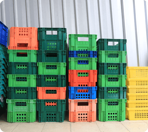 Forklift moving industrial drums in a warehouse