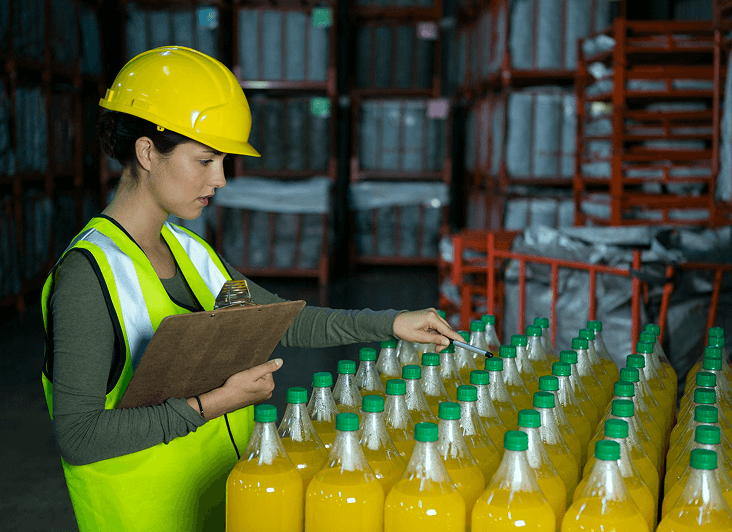 Warehouse worker inspecting yellow bottles